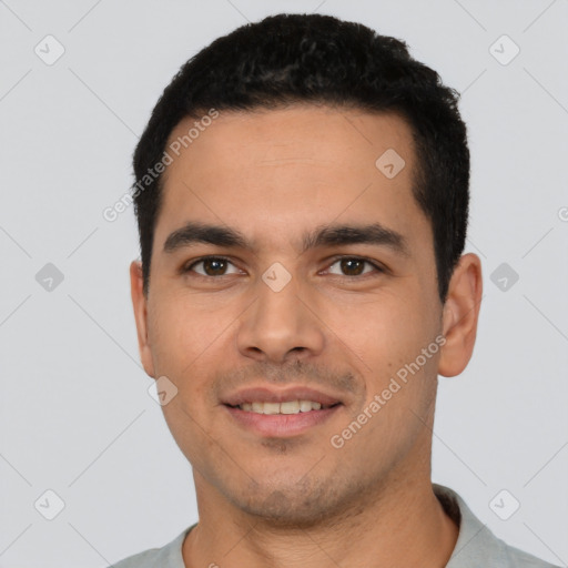 Joyful latino young-adult male with short  black hair and brown eyes