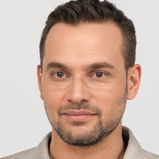 Joyful white adult male with short  brown hair and brown eyes