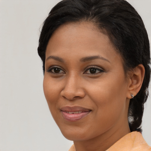 Joyful black young-adult female with medium  brown hair and brown eyes