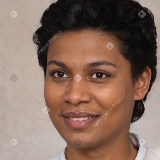 Joyful black young-adult female with short  black hair and brown eyes