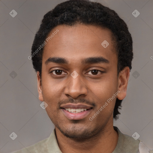 Joyful black young-adult male with short  black hair and brown eyes