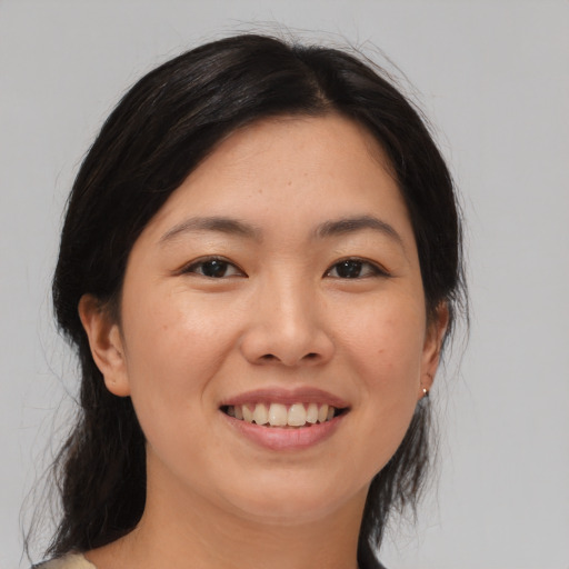Joyful asian young-adult female with medium  black hair and brown eyes