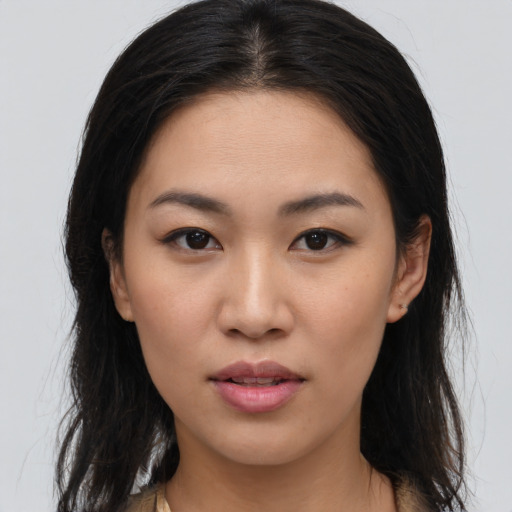 Joyful asian young-adult female with long  brown hair and brown eyes
