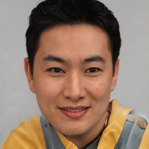 Joyful asian young-adult male with short  brown hair and brown eyes