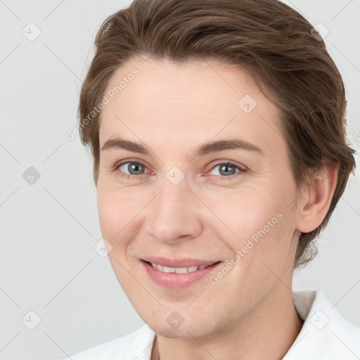 Joyful white young-adult female with short  brown hair and grey eyes