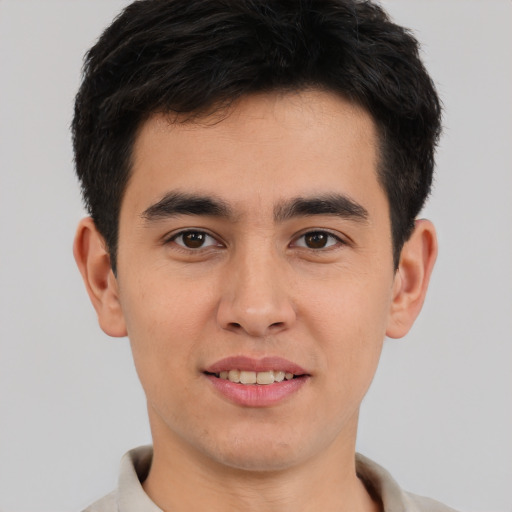 Joyful asian young-adult male with short  brown hair and brown eyes