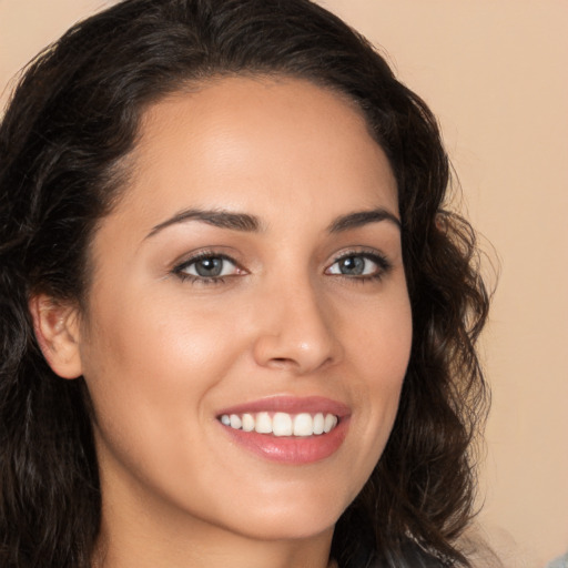 Joyful white young-adult female with long  brown hair and brown eyes