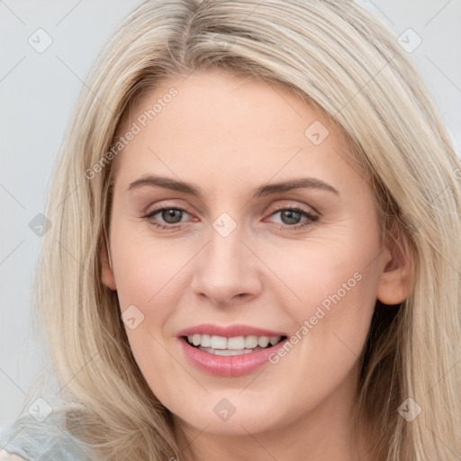 Joyful white young-adult female with long  brown hair and blue eyes