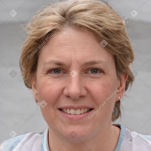 Joyful white adult female with short  brown hair and grey eyes