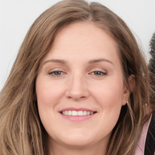 Joyful white young-adult female with long  brown hair and grey eyes