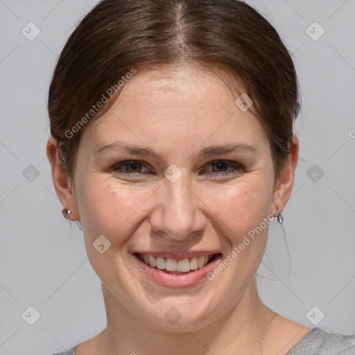 Joyful white adult female with medium  brown hair and grey eyes