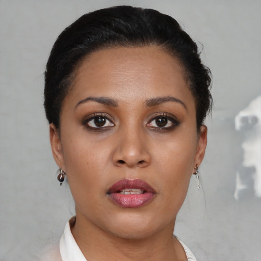 Joyful latino young-adult female with short  brown hair and brown eyes