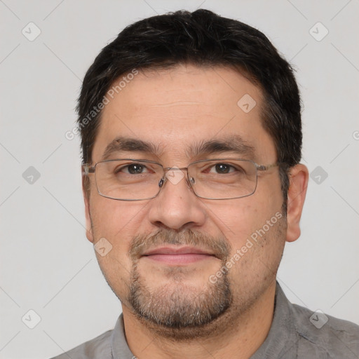 Joyful white adult male with short  black hair and brown eyes