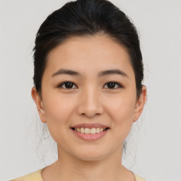 Joyful asian young-adult female with medium  brown hair and brown eyes