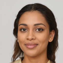 Joyful latino young-adult female with medium  brown hair and brown eyes