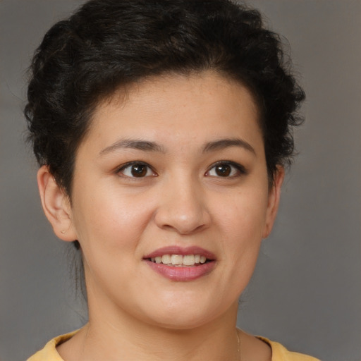 Joyful latino young-adult female with short  brown hair and brown eyes