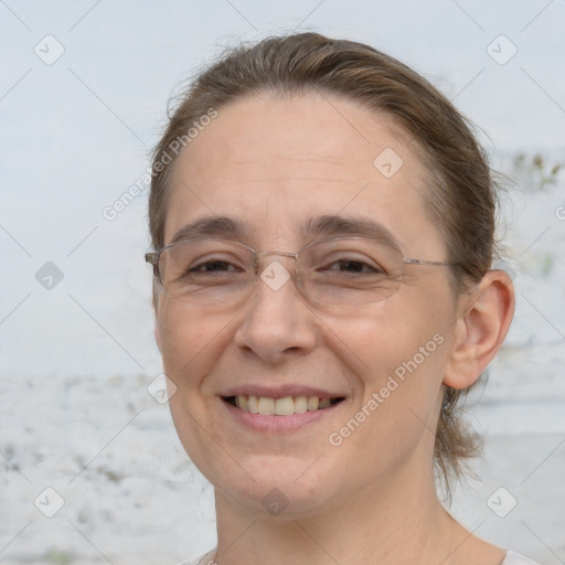 Joyful white adult female with medium  brown hair and brown eyes