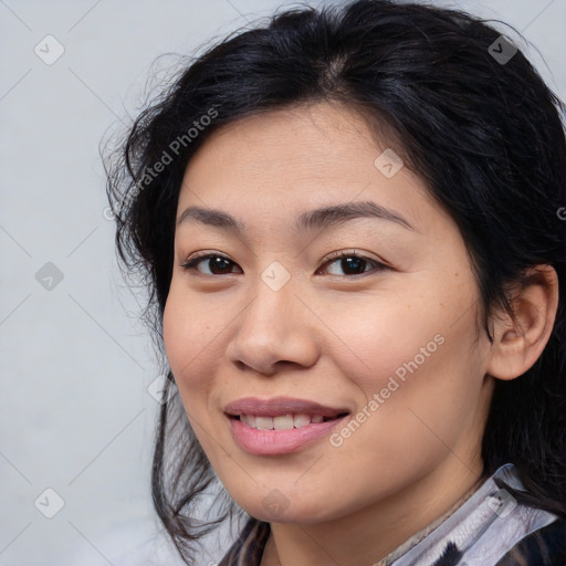 Joyful latino young-adult female with medium  brown hair and brown eyes