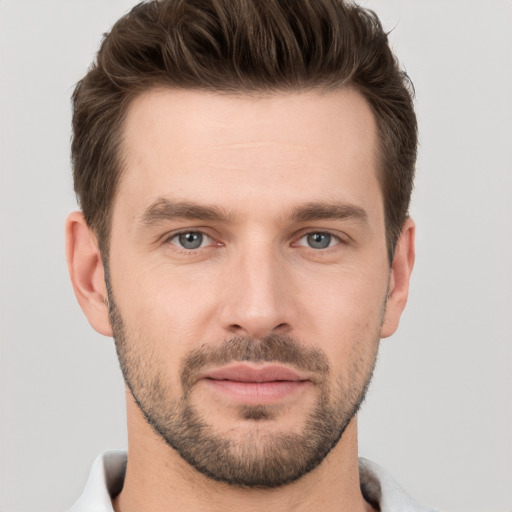 Joyful white young-adult male with short  brown hair and brown eyes