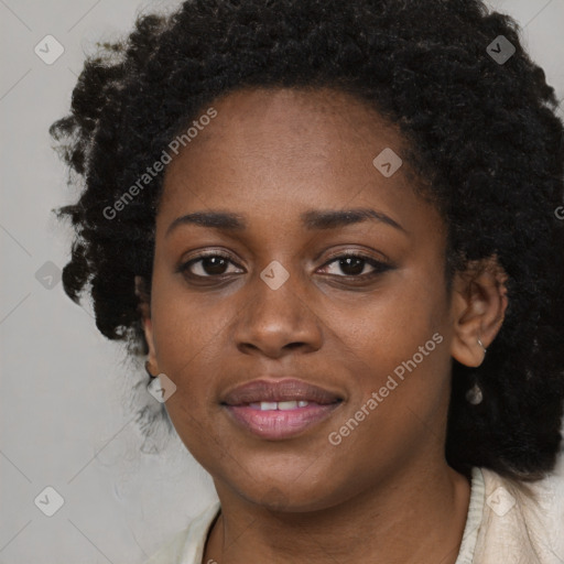 Joyful black young-adult female with long  brown hair and brown eyes