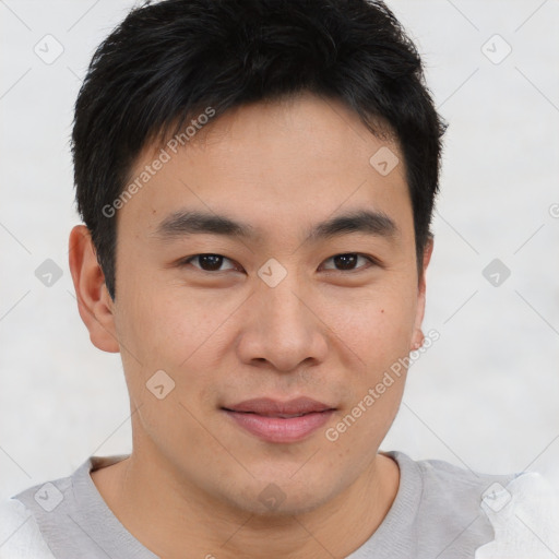 Joyful asian young-adult male with short  brown hair and brown eyes