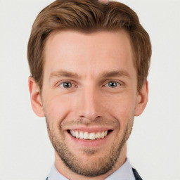 Joyful white young-adult male with short  brown hair and grey eyes