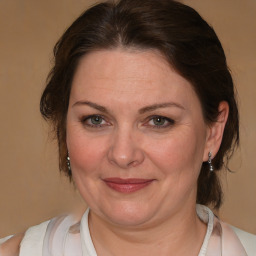 Joyful white adult female with medium  brown hair and brown eyes