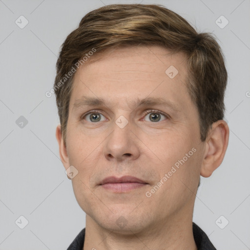 Joyful white adult male with short  brown hair and grey eyes