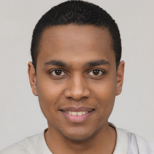 Joyful black young-adult male with short  black hair and brown eyes