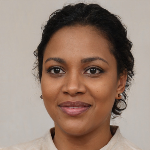 Joyful black young-adult female with medium  brown hair and brown eyes