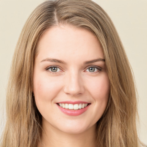 Joyful white young-adult female with long  brown hair and green eyes