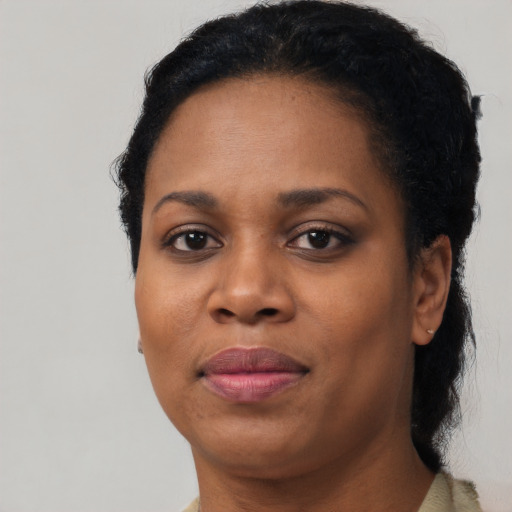 Joyful black adult female with short  black hair and brown eyes