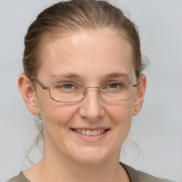 Joyful white adult female with short  brown hair and grey eyes