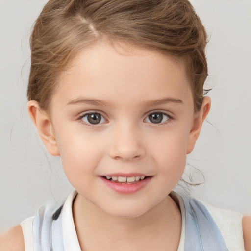 Joyful white child female with short  brown hair and brown eyes