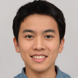 Joyful asian young-adult male with short  black hair and brown eyes