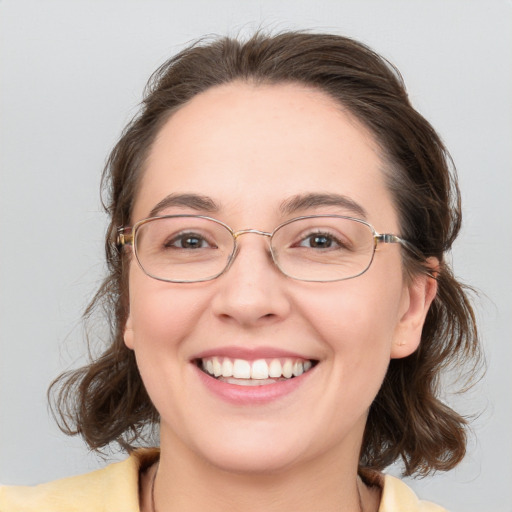 Joyful white adult female with medium  brown hair and blue eyes