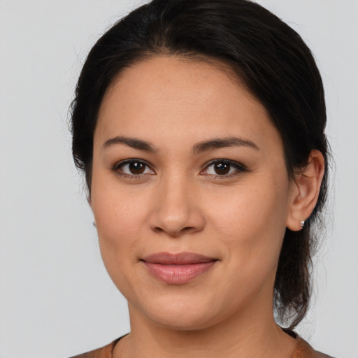 Joyful latino young-adult female with medium  brown hair and brown eyes