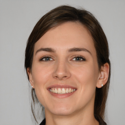 Joyful white young-adult female with medium  brown hair and brown eyes