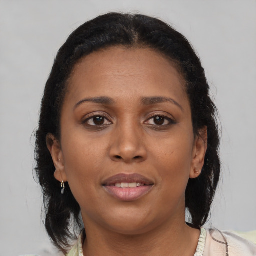 Joyful black young-adult female with medium  brown hair and brown eyes