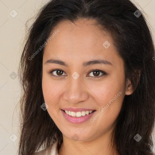 Joyful latino young-adult female with long  brown hair and brown eyes