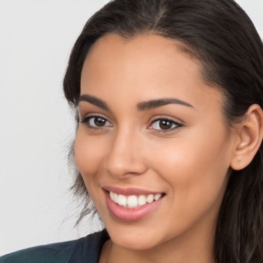 Joyful latino young-adult female with long  brown hair and brown eyes