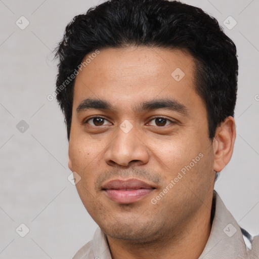 Joyful latino young-adult male with short  black hair and brown eyes