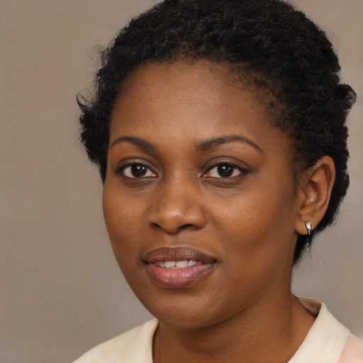 Joyful black young-adult female with medium  black hair and brown eyes