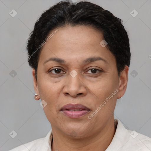 Joyful latino adult female with short  brown hair and brown eyes