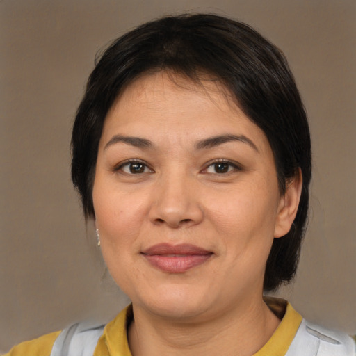 Joyful asian adult female with medium  brown hair and brown eyes