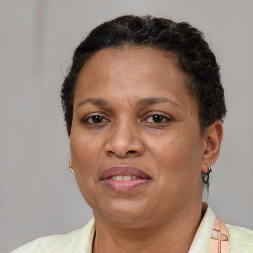 Joyful latino adult female with short  brown hair and brown eyes