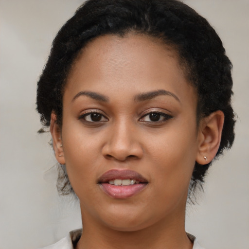Joyful black young-adult female with short  brown hair and brown eyes