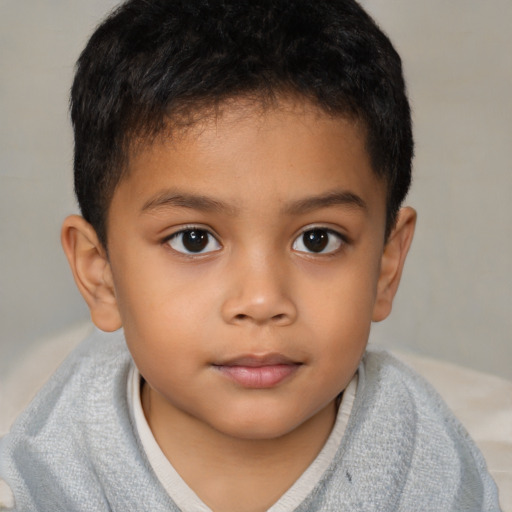 Joyful latino child male with short  brown hair and brown eyes