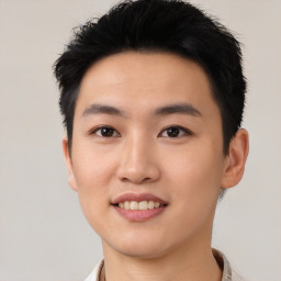 Joyful asian young-adult male with short  black hair and brown eyes