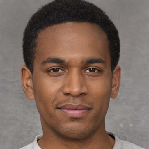 Joyful latino young-adult male with short  brown hair and brown eyes